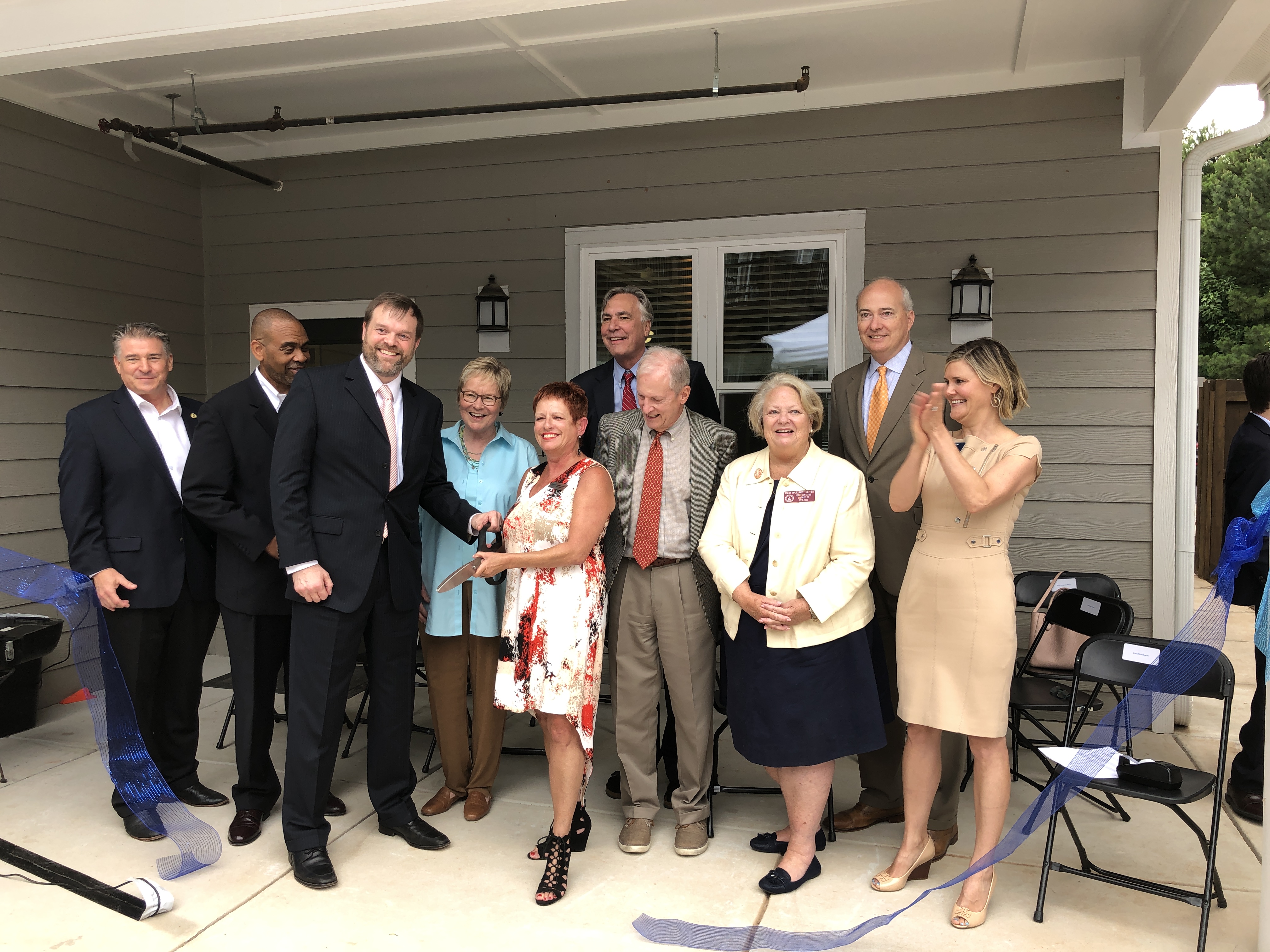 3Keys CEO Darlene Schultz is surrounded by state legislators and government officials during the Rosalynn Apartments reopening ceremony. 