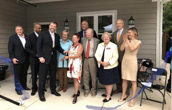 3Keys CEO Darlene Schultz is surrounded by state legislators and government officials during the Rosalynn Apartments reopening ceremony. 